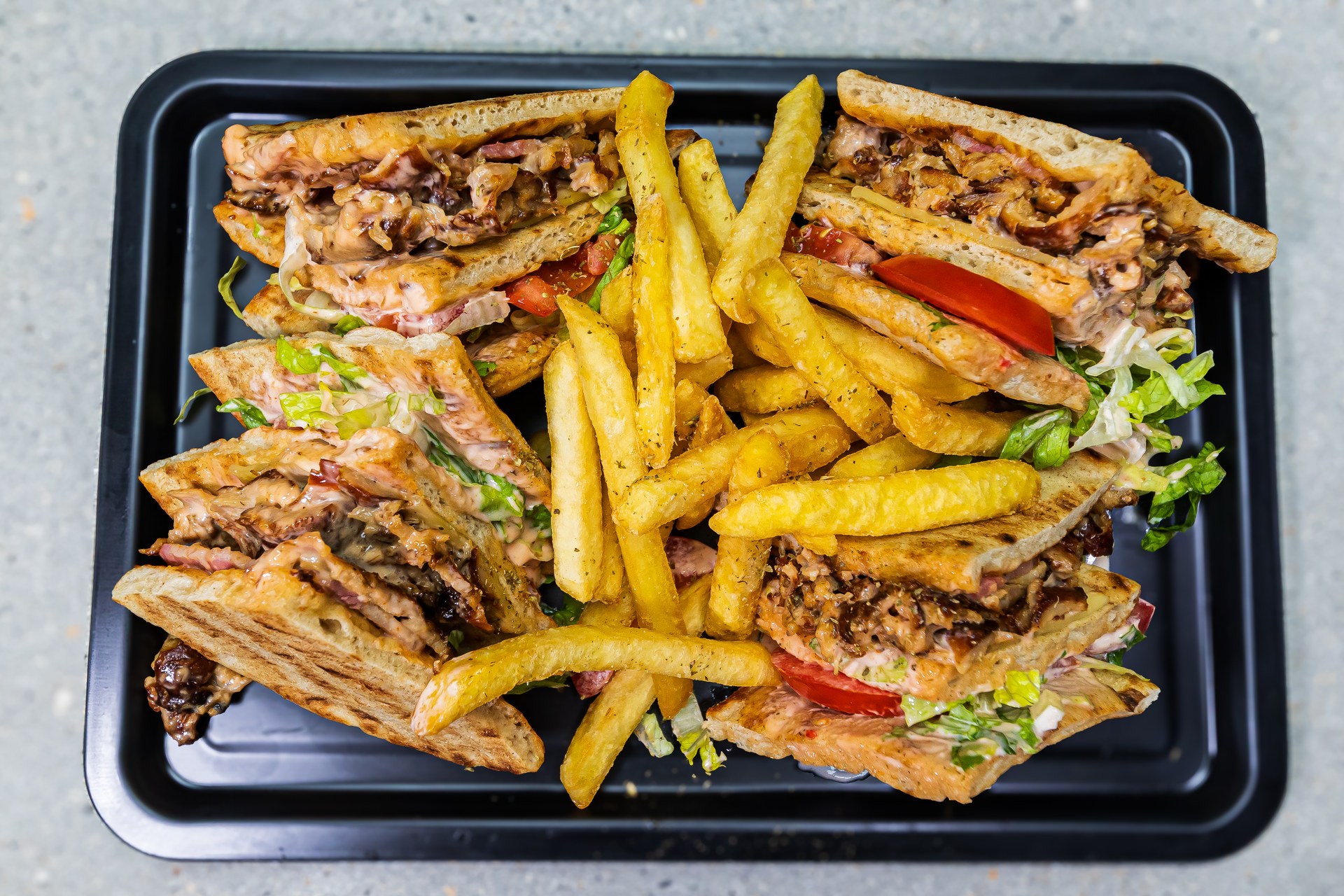Pitta Club Family - 3 stacked pitta breads with pork and chicken, bacon, gouda cheese and special mayo-ketchup sauce - Cristinas Greek Souvlaki Daventry